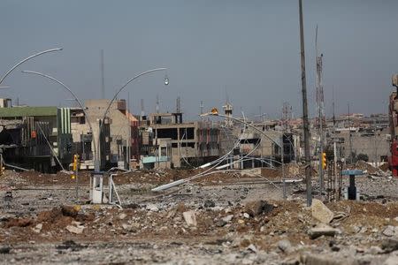 Streetlights and debris lie on the ground of a street in an area where Iraqi forces fought the Islamic State, in Mosul, Iraq, April 4, 2017. REUTERS/Andres Martinez Casares