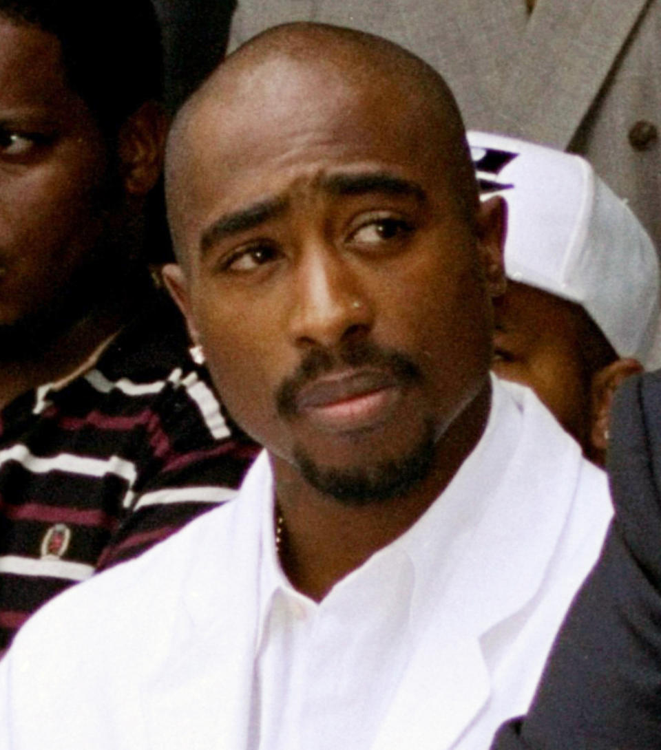 FILE - Rapper Tupac Shakur attends a voter registration event in South Central Los Angeles on Aug. 15, 1996. Shakur’s handwritten lyrics from classic songs such as “California Love” and “Dear Momma” along galleries that pay homage to his upbringing and mother are among the artifacts featured in a massive touring museum exhibit. The Shakur Estate announced Tuesday, Nov. 2, 2021, that the “Tupac Shakur. Wake Me When I’m Free” will open on Jan. 21, 2022, in Los Angeles. (AP Photo/Frank Wiese, File)