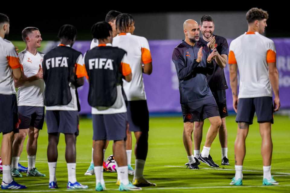 Manchester City's head coach Pep Guardiola applauds, third right, next to his players during a training session at the King Abdullah Sports City Stadium in Jeddah, Saudi Arabia, Monday, Dec. 18, 2023. Urawa Reds will play against Manchester City during the semifinal soccer match during the Club World Cup on Tuesday Dec. 19.(AP Photo/Manu Fernandez)