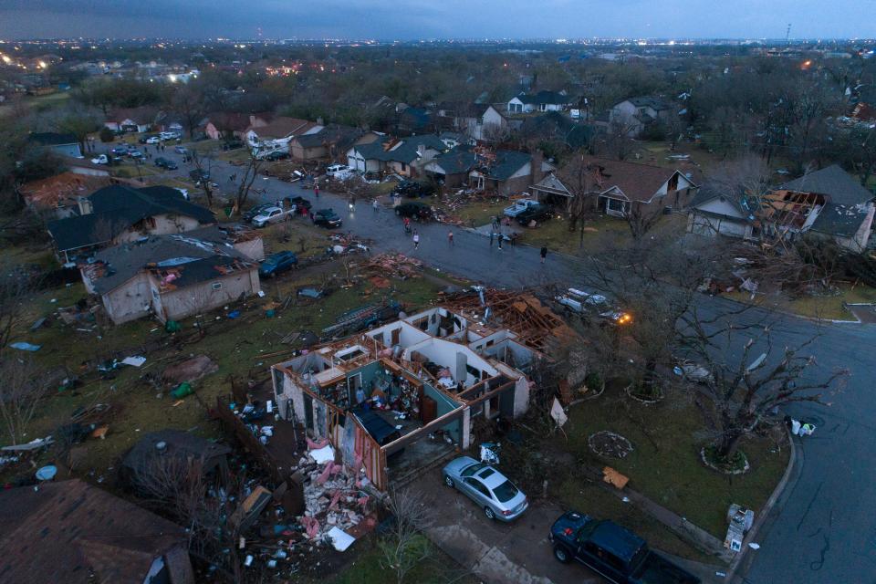 Debris litters the ground surrounding homes, damaged by a tornado, on Oxford Drive and Stratford Drive in Round Rock (AP)