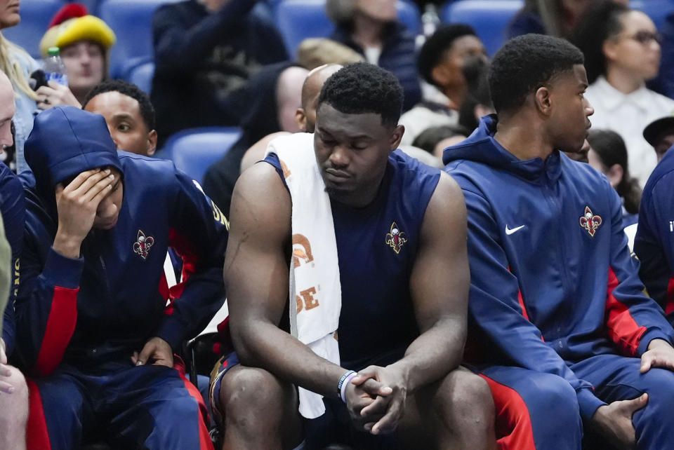 New Orleans Pelicans guard Jordan Hawkins, left, forward Zion Williamson and forward E.J. Liddell react from the bench in the second half of an NBA basketball game against the Orlando Magic in New Orleans, Wednesday, April 3, 2024. The Magic won 117-108. (AP Photo/Gerald Herbert)