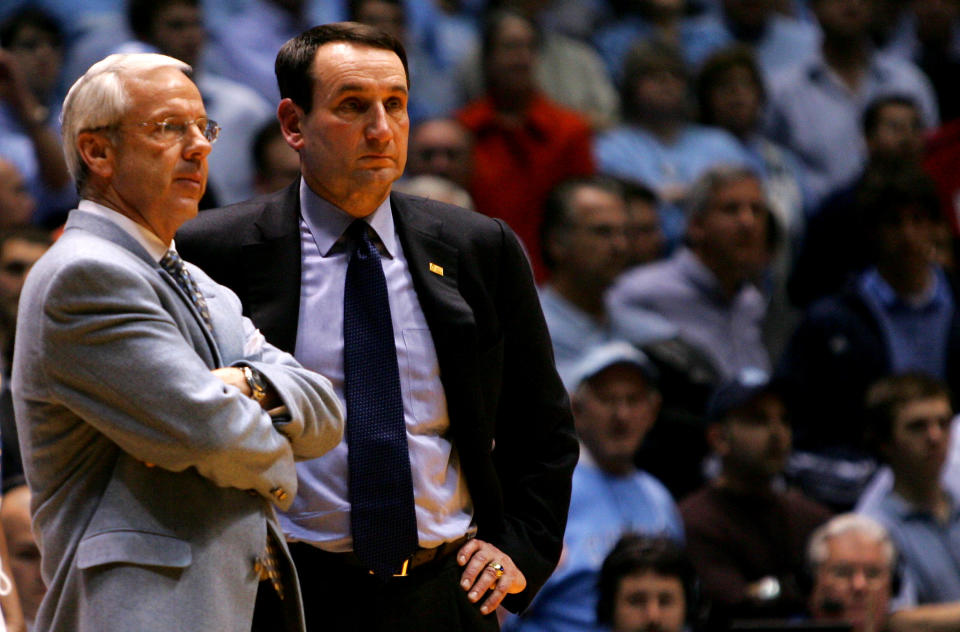 CHAPEL HILL, NC - MARCH 04:  Head coach Mike Krzyzewski (R) of the Duke Blue Devils waits on the officials with head coach Roy Williams of the University of North Carolina Tar Heels after an incident involving Tyler Hansbrough and Gerald Henderson during their game at the Dean E. Smith Center on March 4, 2007 in Chapel Hill, North Carolina. North Carolina defeated Duke, 86 - 72.  (Photo by Streeter Lecka/Getty Images)