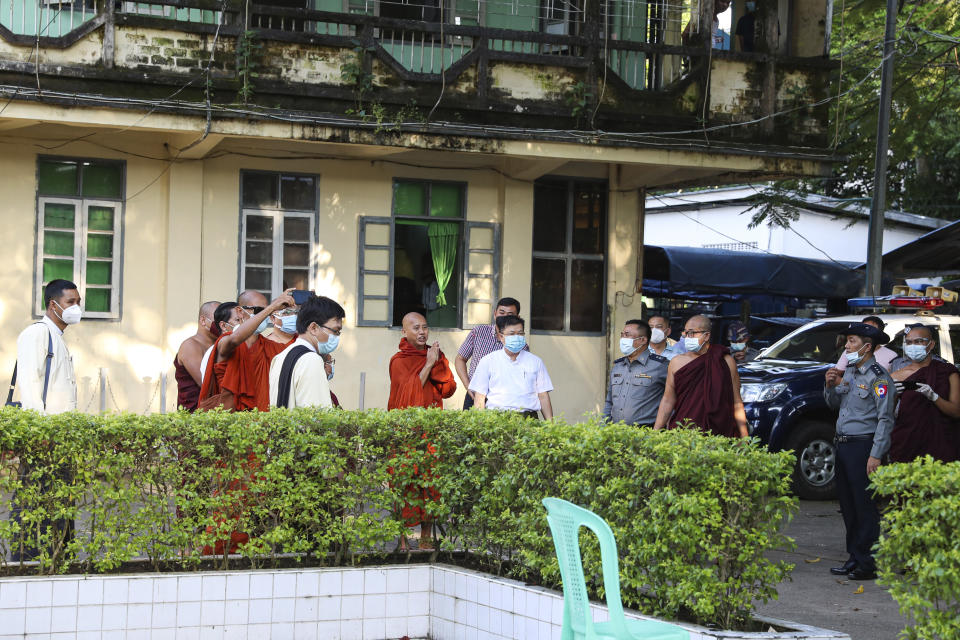 Buddhist monk Wirathu, center, gestures to his followers at a police station in Yangon, Myanmar, Monday Nov. 2, 2020. Wirathu, a nationalist Buddhist monk in Myanmar noted for his inflammatory rhetoric, has surrendered to police, who have been seeking his arrest for over a year for insulting comments he made about the country’s leader, State Counsellor Aung San Suu Kyi. (AP Photo/Thein Zaw)