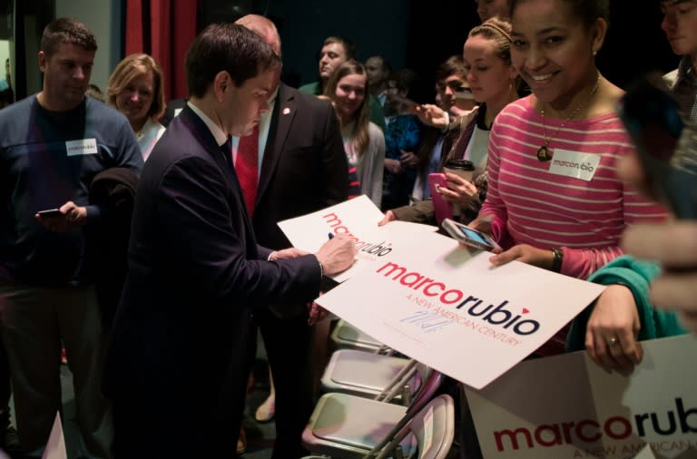 Republican presidential candidate Marco Rubio (2nd L) signs autographs for supporters during a town hall meeting in Beaufort, South Carolina, February 16, 2016