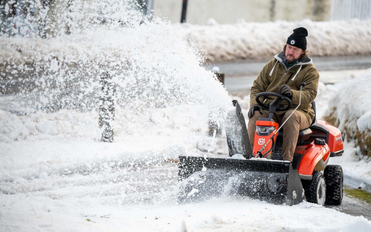 A man clears snow in Aberdeenshire after Storm Gerrit brought widespread disruption to Scotland