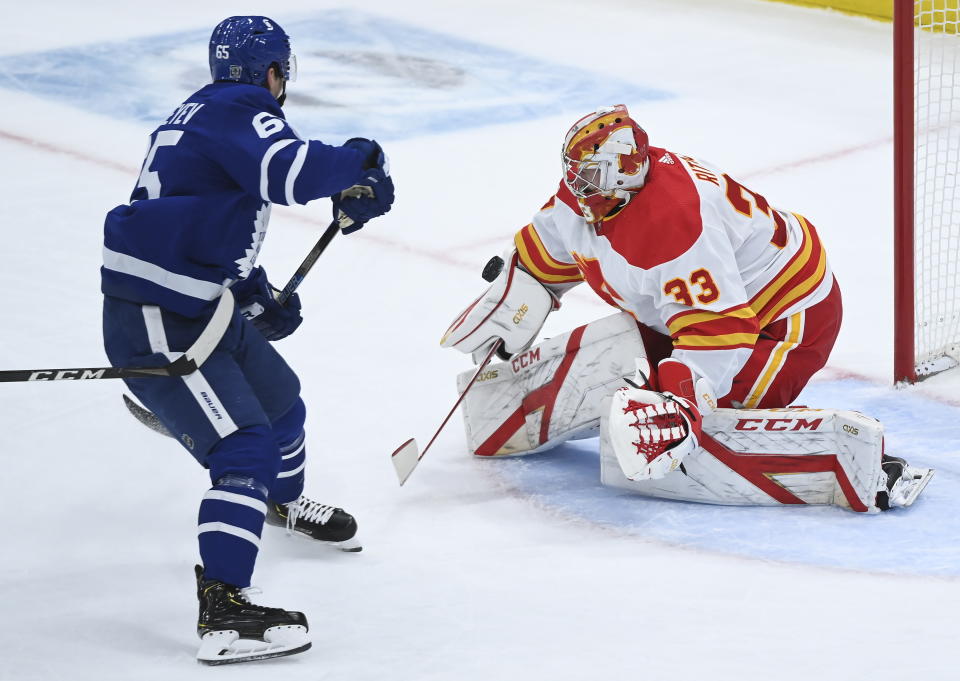 Calgary Flames goaltender David Rittich (33) makes a save against Toronto Maple Leafs right wing Ilya Mikheyev (65) on a breakaway during second-period NHL hockey game action in Toronto, Monday, Feb. 22, 2021. (Nathan Denette/The Canadian Press via AP)