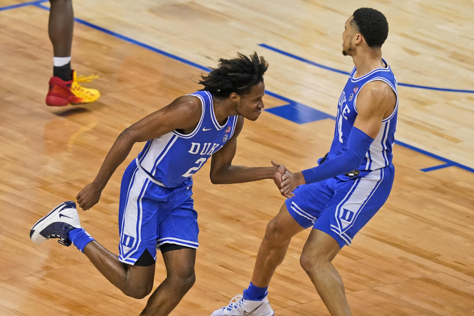 Duke guard DJ Steward (2) celebrates a basket with teammate Duke guard Jordan Goldwire, right, during the second half of an NCAA college basketball game in the second round of the Atlantic Coast Conference tournament in Greensboro, N.C., Wednesday, March 10, 2021. Duke defeated Louisville 70-56. (AP Photo/Gerry Broome)