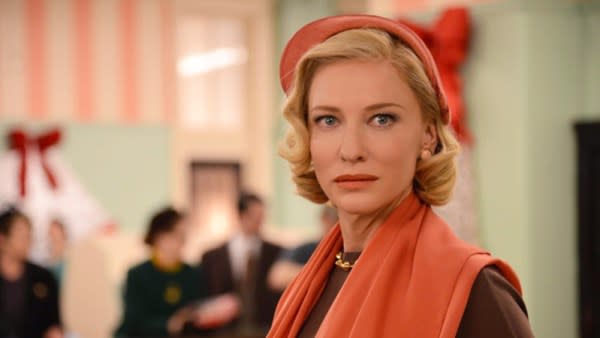 A queer Halloween costume for 2023. The image Cate Blanchett, who appears as a lesbian character, Carol Aird. She is in a department store, pictured from the shoulders up and wearing a red fascinator hat.