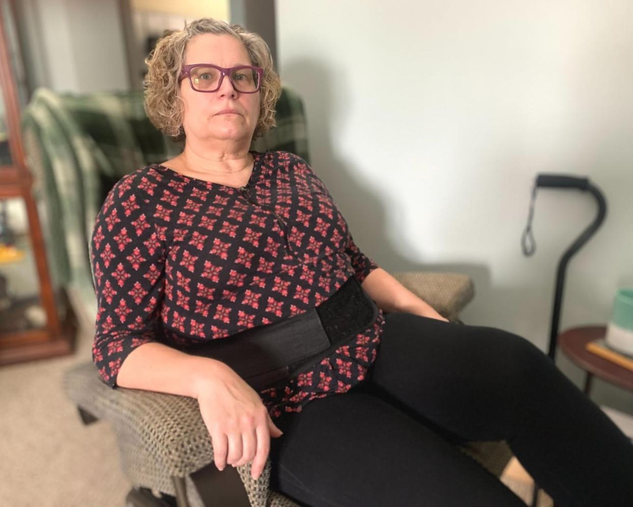 Judy Harvey of Happy Valley-Goose Bay deals with chronic pain around the clock, related to a back injury and three surgeries. She’s waiting on word from the province’s workers' compensation program about what could be her final treatment option. (John Gaudi/CBC - image credit)