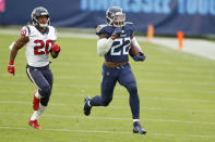 Tennessee Titans running back Derrick Henry (22) beats Houston Texans strong safety Justin Reid (20) as Henry runs 94 yards for a touchdown in the second half of an NFL football game Sunday, Oct. 18, 2020, in Nashville, Tenn. (AP Photo/Wade Payne)