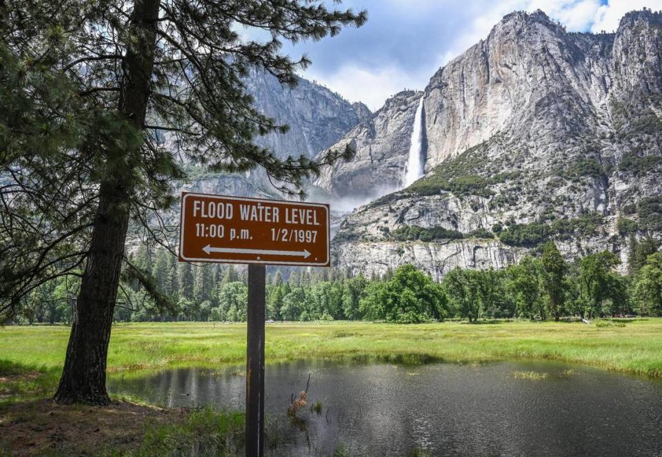 A marker shows the level of the 1997 Yosemite Valley flood while the meadow across from Upper Yosemite Falls has flooded but not nearly at that level in Yosemite Valley on Tuesday, June 14, 2023.