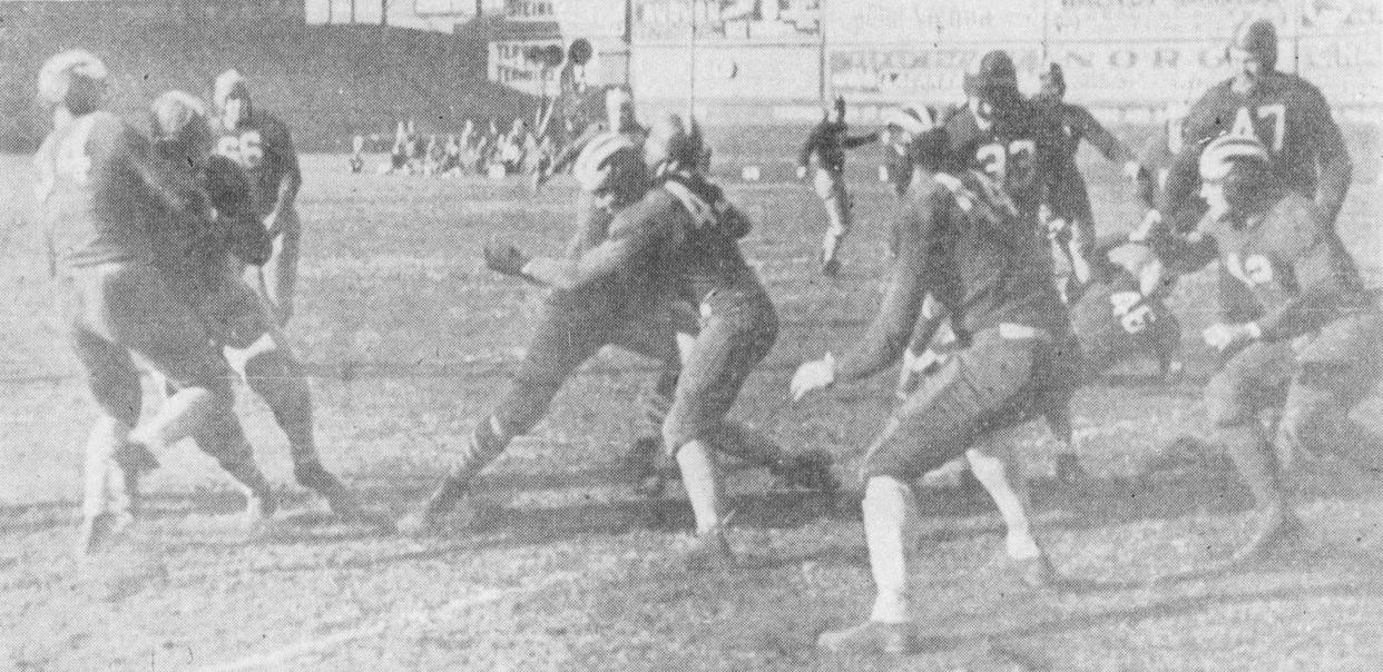 The Cincinnati Reds football team, in striped helmets, against the Portsmouth Spartans in a 1933 game at Redland Field.