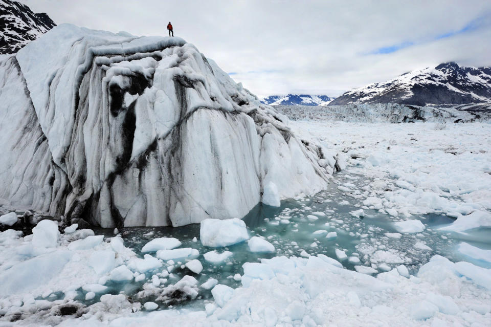 This 2008 photo released by Extreme Ice Survey shows field technician, Adam LeWinter on an iceberg in Columbia Bay, Alaska during the filming of "Chasing Ice." The film, about climate change, follows National Geographic photographer James Balog across the Arctic as he deploys revolutionary time-lapse cameras designed to capture a multi-year record of the world's changing glaciers. (AP Photo/Extreme Ice Survey, James Balog)