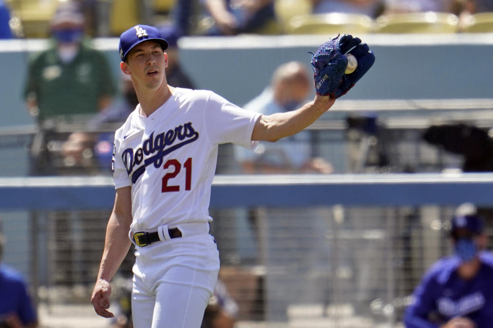 Los Angeles Dodgers starting pitcher Walker Buehler gets the ball back from the infield after recording an out during the fourth inning of a baseball game against the Washington Nationals, Friday, April 9, 2021, in Los Angeles. (AP Photo/Marcio Jose Sanchez)