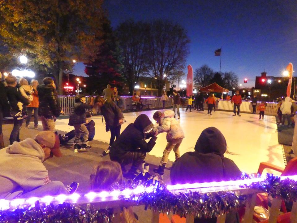 Skaters slip and slide on the iceless rink set up in Washington Square on Thursday evening during the Bucyrus Area Chamber of Commerce's annual Candlelight Christmas.