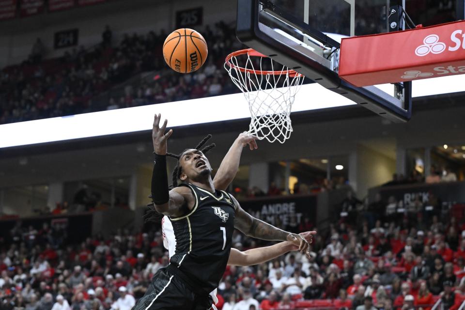 Central Florida guard Antwann Jones (1) reaches for a rebound against Central Florida during the first half of an NCAA college basketball game, Saturday, Feb. 10, 2024, in Lubbock, Texas. (AP Photo/Justin Rex)