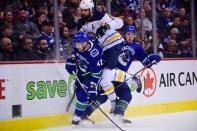 Jan 18, 2019; Vancouver, British Columbia, CAN; Vancouver Canucks forward Sven Baertschi (47) and forward Jake Virtanen (18) check Buffalo Sabres defenseman Zach Bogosian (4) during the first period at Rogers Arena. Mandatory Credit: Anne-Marie Sorvin-USA TODAY Sports