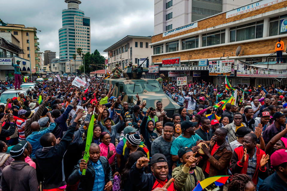 <p>People cheer a passing Zimbabwe Defense Force military vehicle during a demonstration demanding the resignation of Zimbabwe’s president on Nov. 18, 2017 in Harare. (Photo: Jekesai Njikizana/AFP/Getty Images) </p>