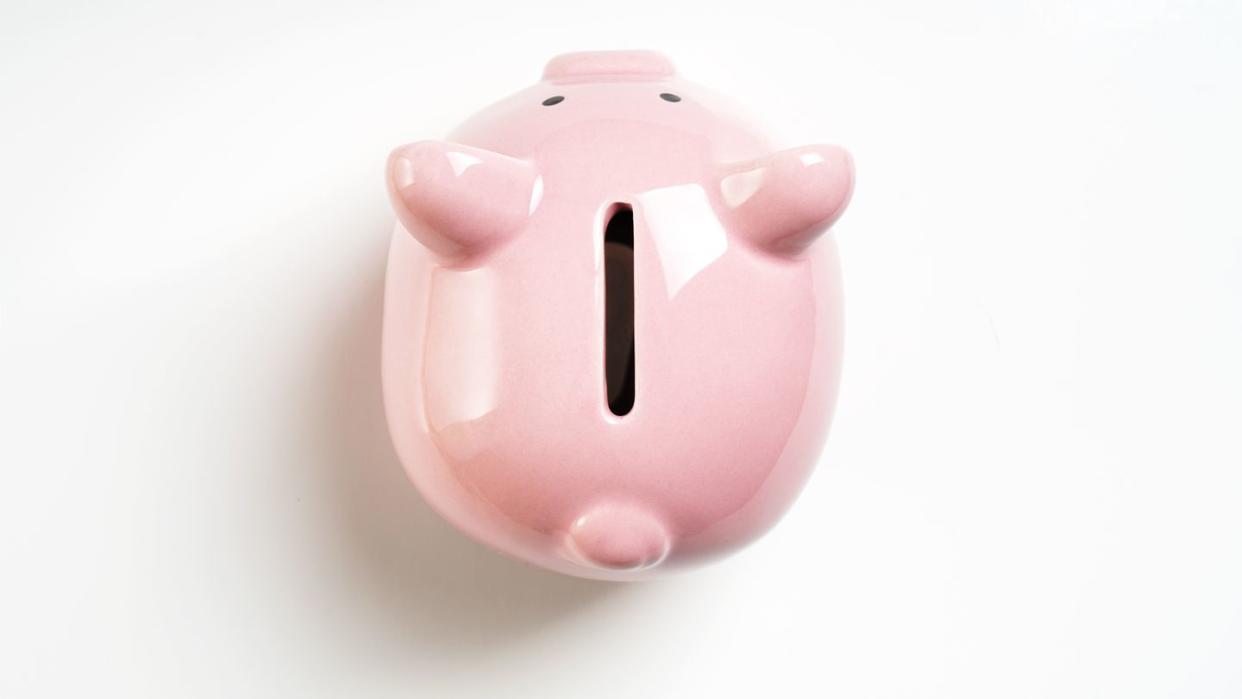 new years resolutions close up of piggy bank on white background