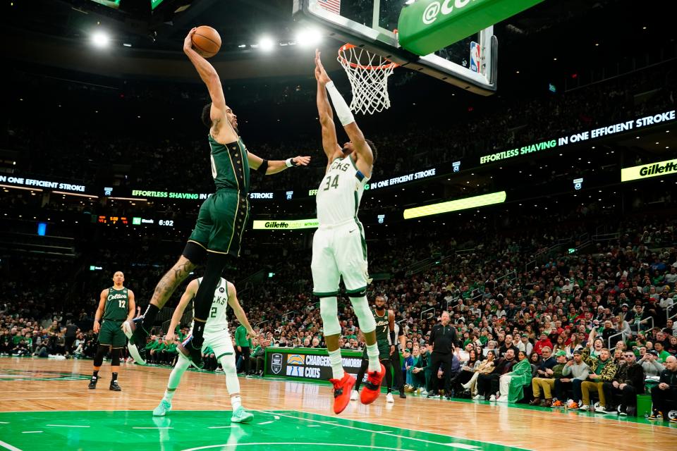 Celtics forward Jayson Tatum dunks against the Bucks' Giannis Antetokounmpo on his way to 41 points Sunday at TD Garden in Boston.