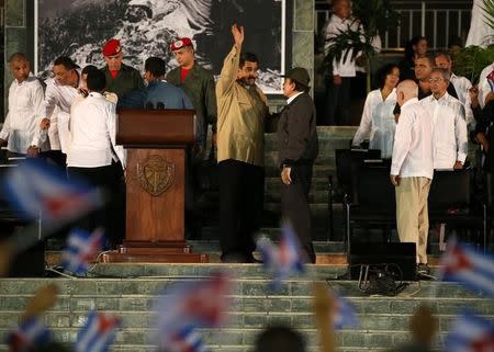 Venezuelan President Nicolas Maduro (L) waves as he speaks with Nicaraguan President Daniel Ortega as they attend a tribute in honor of former Cuban leader Fidel Castro in Santiago de Cuba, Cuba, December 3, 2016. REUTERS/Carlos Garcia Rawlins