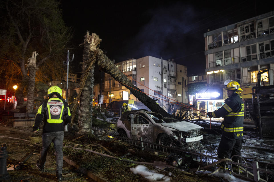 An Israeli firefighter works at the site where a rocket fired from the Gaza Strip, hit the central Israeli town of Holon, near Tel Aviv, Tuesday, May 11, 2021. A confrontation between Israel and Hamas sparked by weeks of tensions in contested Jerusalem escalated Tuesday as Israel unleashed new airstrikes on Gaza while militants barraged Israel with hundreds of rockets. (AP Photo/Heidi Levine)