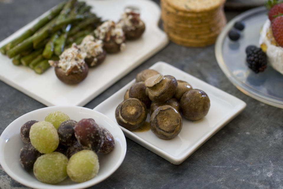 This Nov. 4, 2013 photo shows sugared grapes, stuffed mushrooms, marinated mushrooms and asparagus, in Concord, N.H. (AP Photo/Matthew Mead)