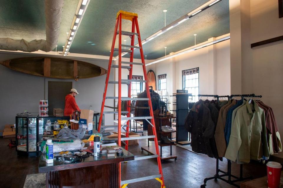 Brendan Bohac helps get ready for the opening of Fairly Local, a new menswear shop in the old post office building in Bay St. Louis on Thursday, Dec. 7, 2023. The shop, which opens Saturday, Dec. 9, will have an in-store barber shop, coffee shop, humidor for cigars and a variety of menswear brands.