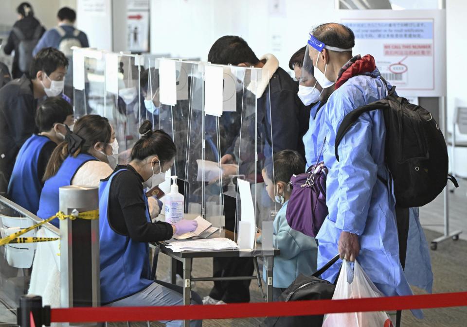 Passengers from Shanghai present proof of a negative COVID-19 test on their arrival at Narita airport near Tokyo on Jan. 8, 2023. China is suspending issuing visas for South Koreans to come to the country for tourism or business in apparent retaliation for COVID-19-related requirements on Chinese travelers. Japan’s Kyodo News service said the ban would also affect Japanese travelers.(Kyodo News via AP)