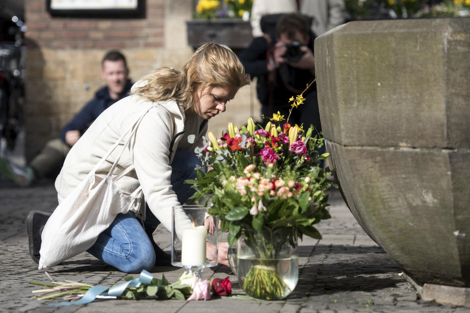 <p>A woman lays down flowers in front of the restaurant Kiepenkerl in Muenster, western Germany, Sunday, April 8, 2018, one day after a van crashed into people drinking outside the popular bar, killing two people and injuring others before the driver of the vehicle shot and killed himself inside it. (Photo: Marcel Kusch/dpa via AP) </p>