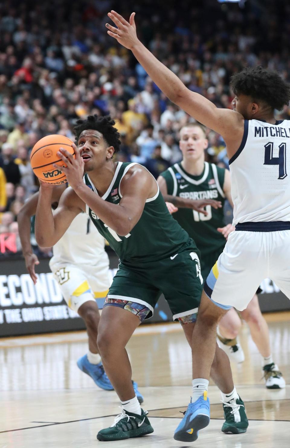 Michigan State Spartans guard A.J. Hoggard scores against Marquette Golden Eagles guard Stevie Mitchell during the second round of the NCAA tournament in Columbus, Ohio, March 19, 2023.