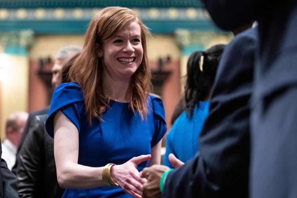 State Sen. Mallory McMorrow shakes hands as she walks into the House of Representatives with Gov. Gretchen Whitmer (not in the photo) during the State of the State address at the State Capitol in Lansing, Wednesday, Jan. 29, 2020.