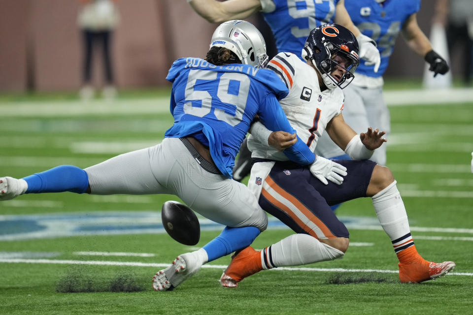 Detroit Lions linebacker James Houston (59) knocks the ball away from Chicago Bears quarterback Justin Fields (1) during the first half of an NFL football game, Sunday, Jan. 1, 2023, in Detroit. (AP Photo/Paul Sancya)
