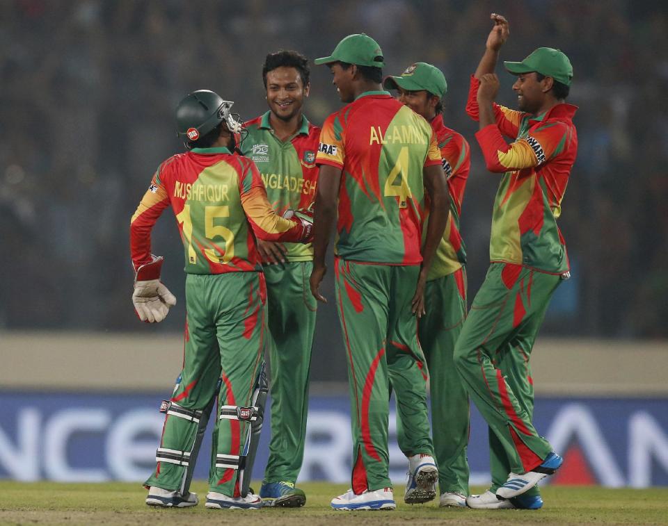 Bangladesh players celebrate the dismissal of West Indies' batsman Lendl Simmons during their ICC Twenty20 Cricket World Cup match in Dhaka, Bangladesh, Tuesday, March 25, 2014. (AP Photo/Aijaz Rahi)