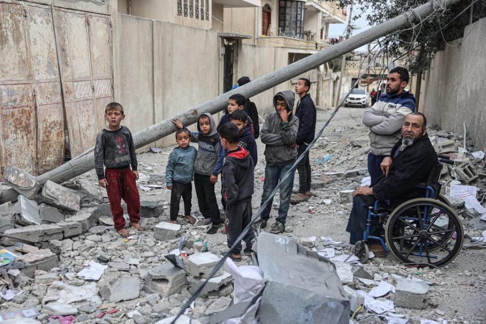 Palestinians look at the rubble of their house which was destroyed in an overnight Israeli airstrike in the Rafah refugee camp in the southern Gaza Strip on Feb. 27, 2024.