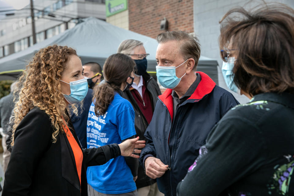 STAMFORD, CONNECTICUT - MARCH 14: CT Governor Ned Lamont (D-CT) and Building One Community executive director Anka Badurina (L) speak outside a COVID-19 community vaccination clinic on March 14, 2021 in Stamford, Connecticut. The non-profit Building One Community organized the event to administer the first dose of the Moderna vaccine to more than 350 people from the immigrant and undocumented communities. The vaccines were supplied by the federal Health Resources and Services Administration (HRSA). Vaccine recipients are due to return in April for their second dose. (Photo by John Moore/Getty Images)