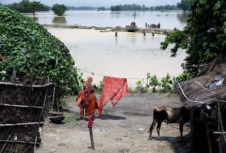 A woman dries cloth in Saptari District, Nepal August 14, 2017. REUTERS/Navesh Chitrakar