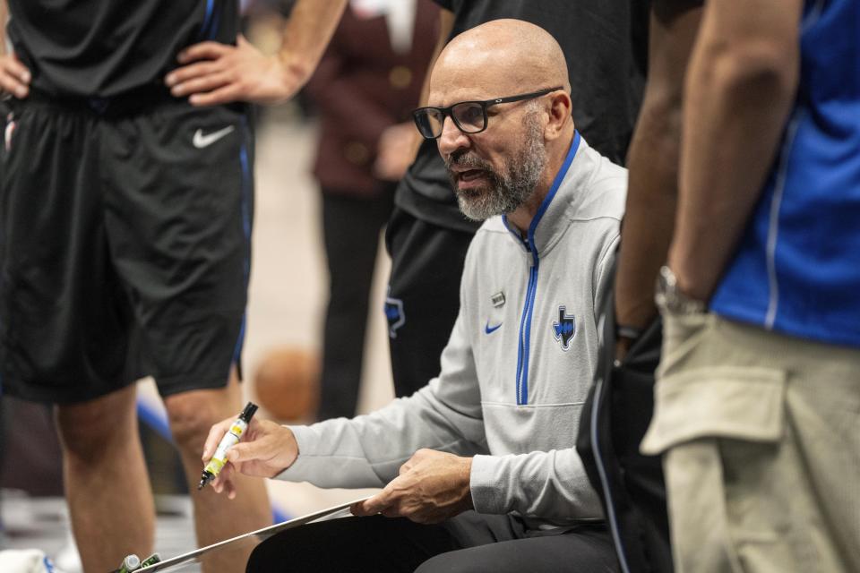 Dallas Mavericks head coach Jason Kidd draws on a whiteboard during a timeout in the first half of an NBA basketball game against the Detroit Pistons, Friday, April 12, 2024, in Dallas. (AP Photo/Jeffrey McWhorter)