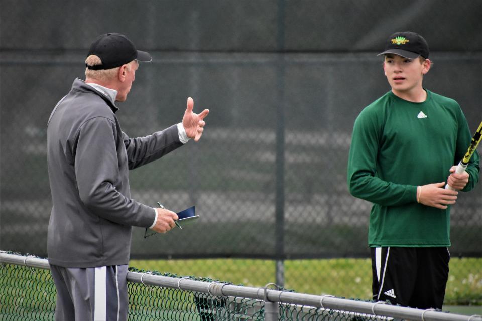 Rock Bridge coach Ben Loeb, left, coaches his son Ben Loeb during a match against Quincy on May 9 in Columbia.