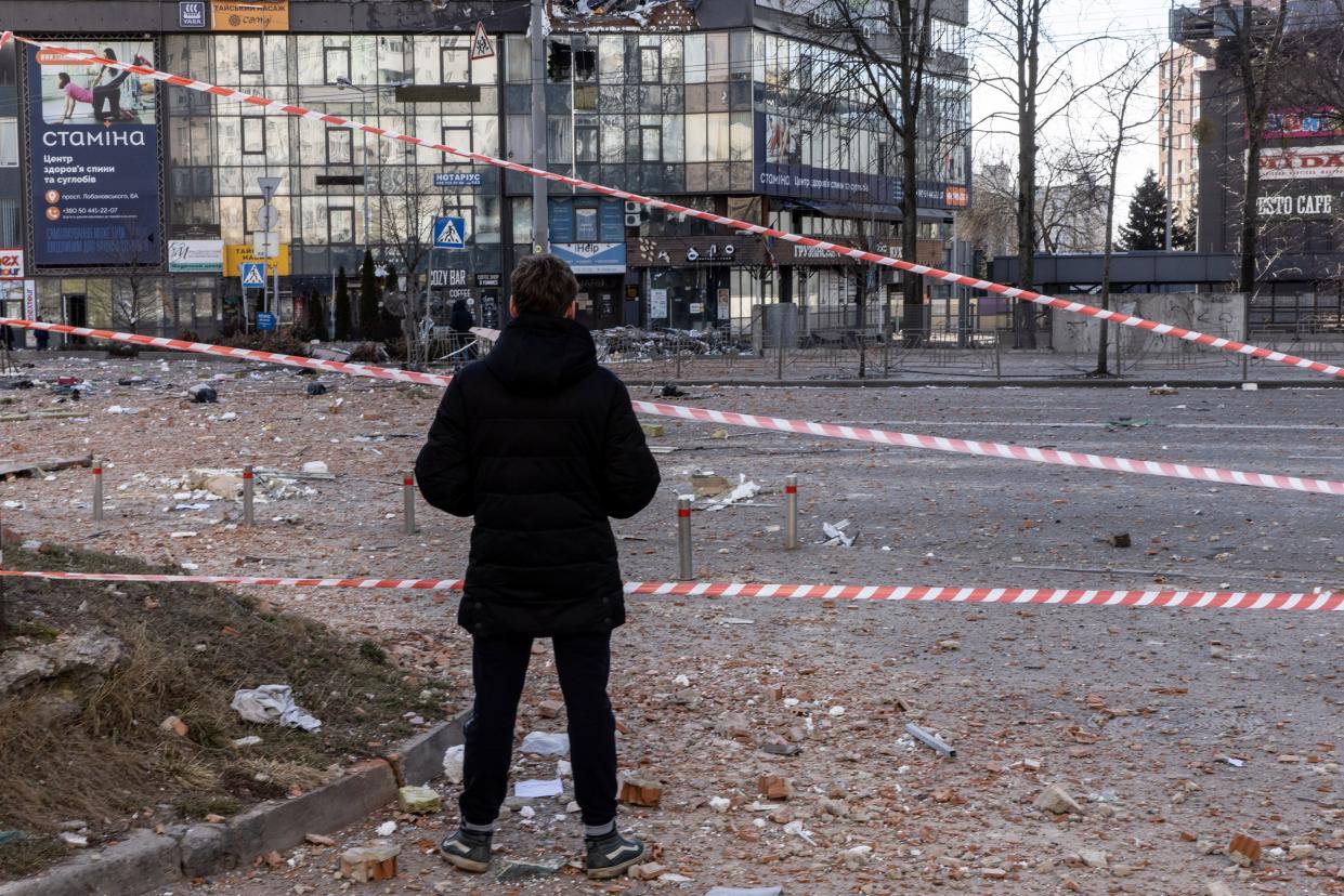 A man looks at damage from a  residential apartment building that was hit by a missile on Feb. 26, 2022, in Kyiv, Ukraine.