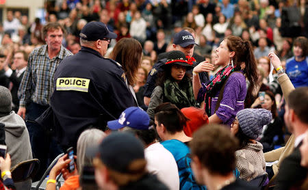 A protester is removed by police as Canada's Prime Minister Justin Trudeau addresses the crowd during a town hall meeting at Vancouver Island University in Nanaimo, British Columbia, Canada, February 2, 2018. REUTERS/Kevin Light