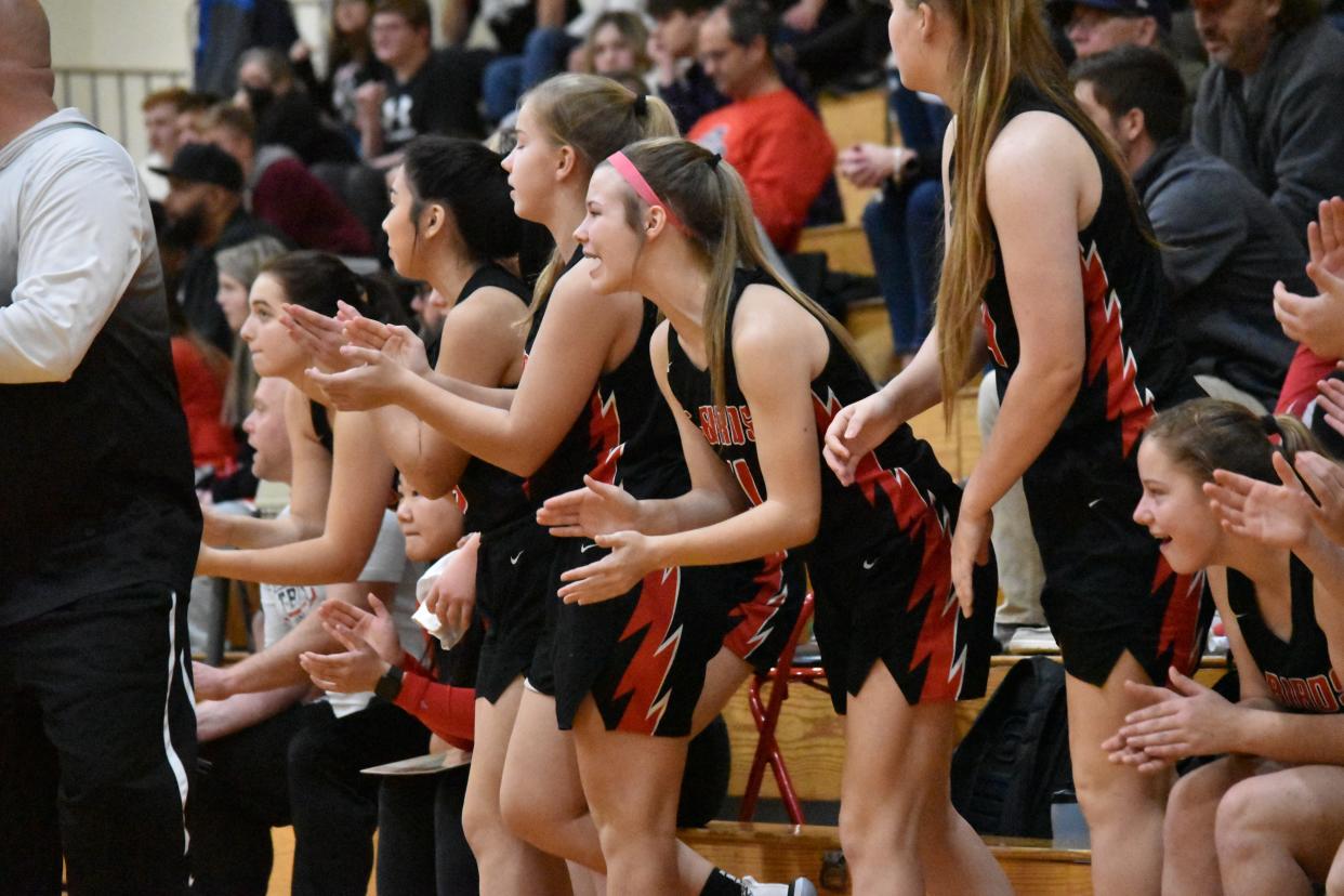 The Eastern Greene bench celebrates after a made basket.