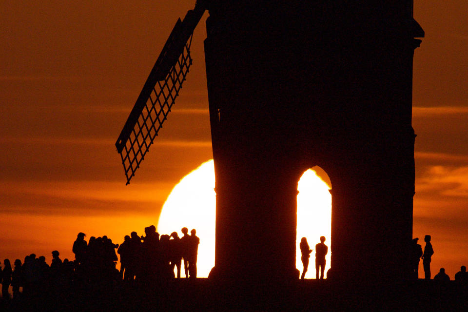 <p>Groups of people watch sunset by Chesterton Windmill in Warwickshire. Picture date: Wednesday March 17, 2021.</p>
