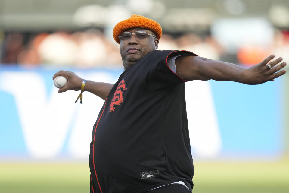 Musician E-40 throws out the ceremonial first pitch before a baseball game between the San Francisco Giants and the Chicago Cubs in San Francisco, Friday, June 9, 2023. (AP Photo/Jeff Chiu)