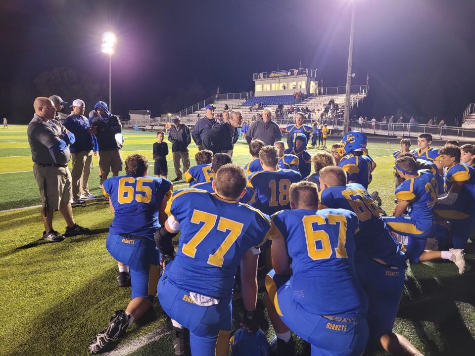 East Canton head coach John "Spider" Miller speaks with his team following Friday's 41-6 win over Strasburg in 2021.