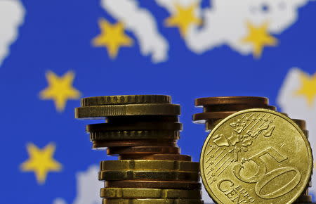 Euro coins are seen in front of displayed flag and map of European Union in this picture illustration taken in Zenica, May 28 2015. REUTERS/Dado Ruvic/Files