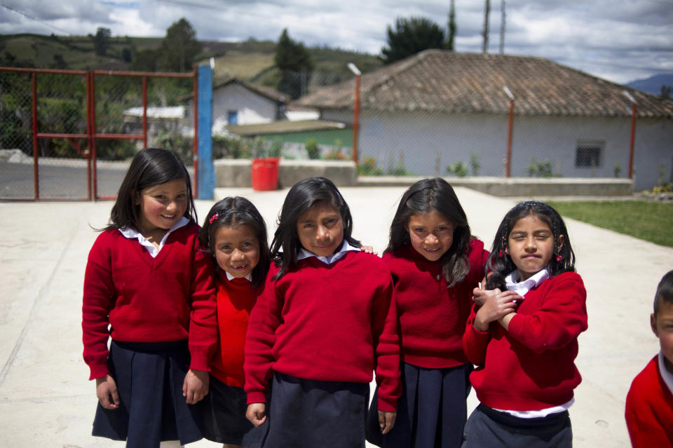 Girls pose at a rural school at La Palizada in Tulcan, Carchi province, in Ecuador close to the Colombian border on November 7, 2012. 