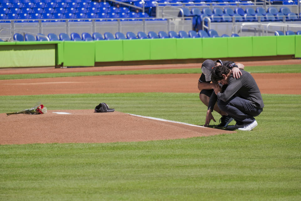 <p>Miami Marlins player Christian Yelich, right, and teammate Justin Bour react in front of a memorial on the pitcher’s mound at Marlins Park for Marlins pitcher Jose Fernanedez, Sunday, Sept. 25, 2016 in Miami. (AP Photo/Gaston De Cardenas) </p>