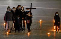 Pope Francis leads the Via Crucis (Way of the Cross) procession during Good Friday celebrations at the Vatican