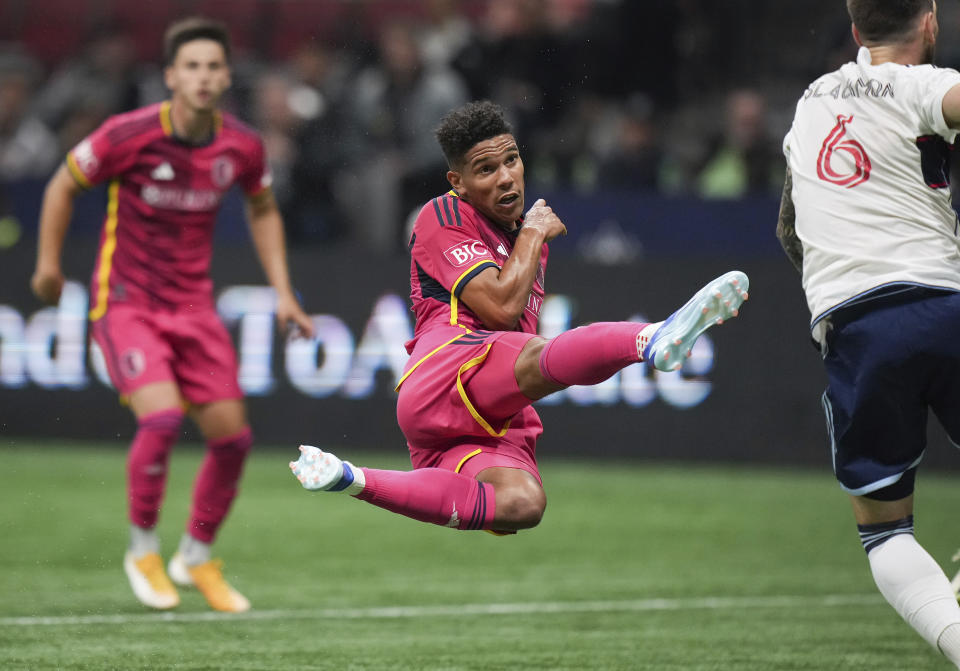 St. Louis City's Nicholas Gioacchini, center, watches the ball heading it toward the goal against the Vancouver Whitecaps during the first half of an MLS soccer match Wednesday, Oct. 4, 2023, in Vancouver, British Columbia. (Darryl Dyck/The Canadian Press via AP)